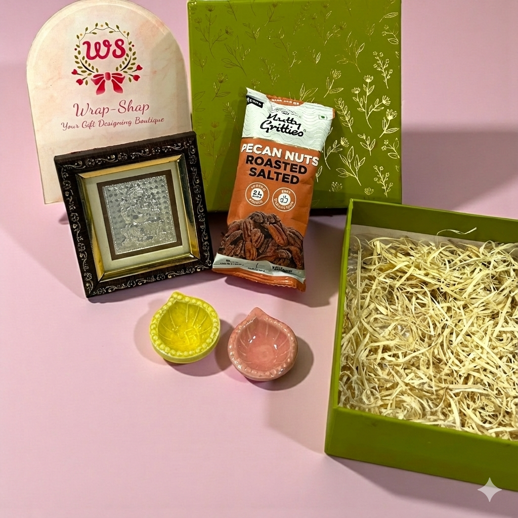 Wedding return favour with Ganesh Ji silver frame, two diyas and roasted nuts in a premium gift box.