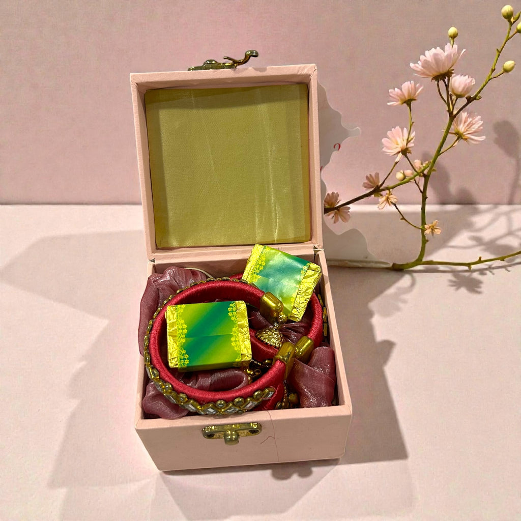 Wedding return gift for ladies featuring bangles, scrunchies and chocolates in premium gift box.