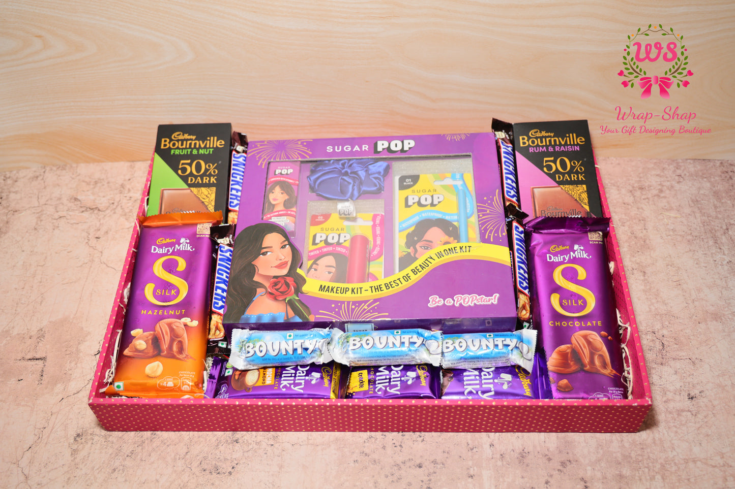 Wrap Shap gift hamper for sister with Sugar Pop makeup kit, assorted chocolates and scrunchie in decorative tray for Raksha Bandhan or festival gifting