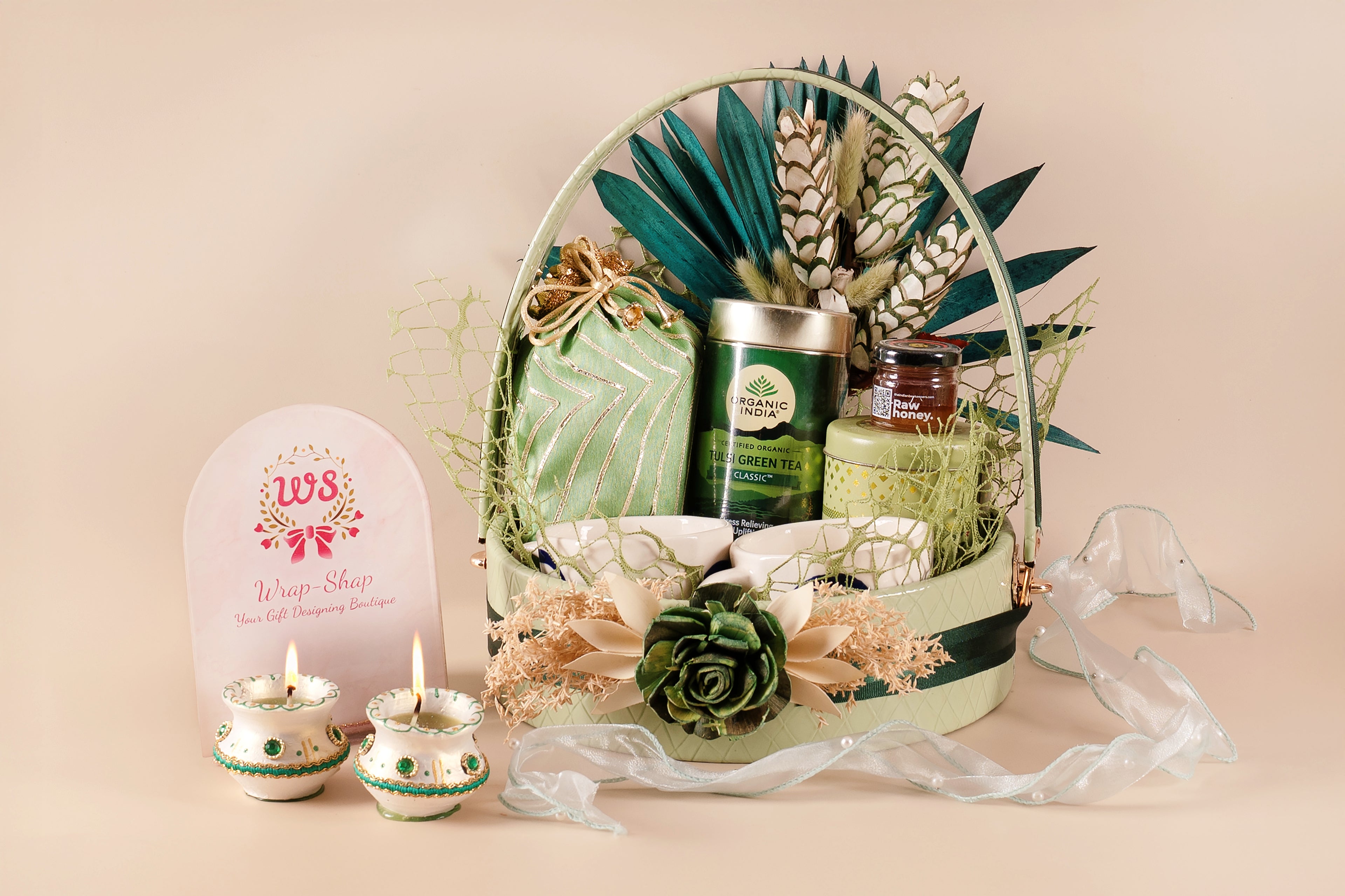 Dry flower decorated leather basket hamper with baked healthy mixture, green tea, healthy nuts mix, honey jar, and 2 tea mugs – ideal for wellness, Diwali, weddings & corporate gifting