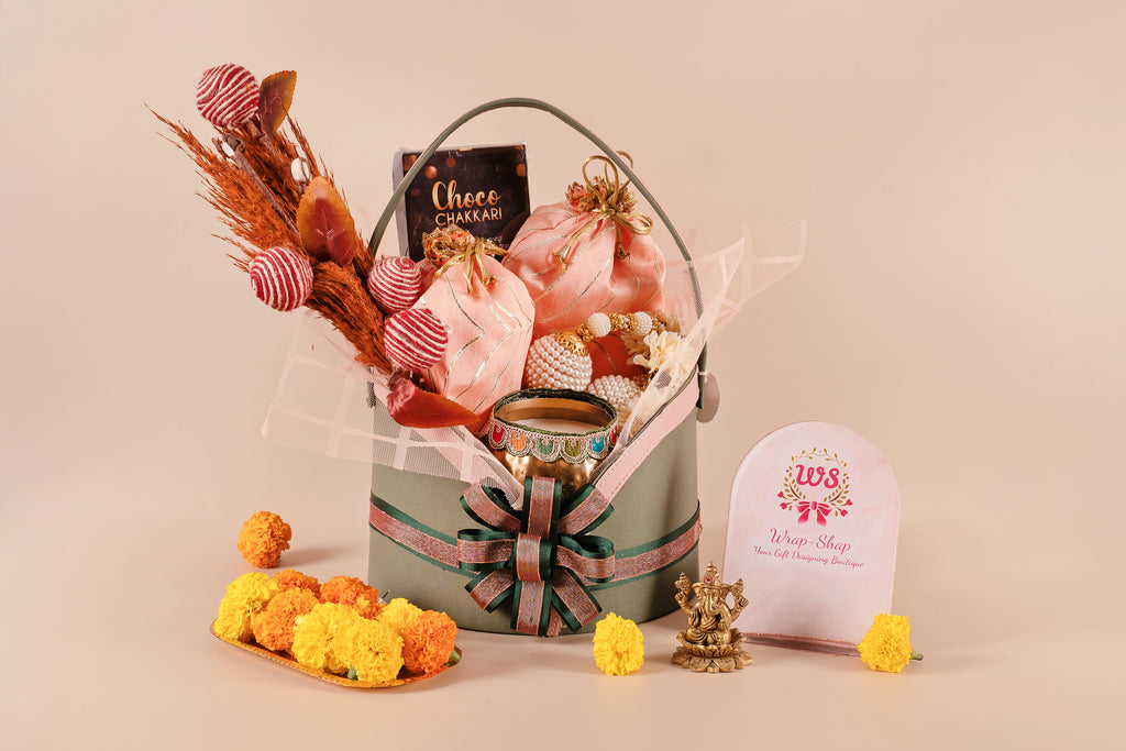 Luxury leather basket gift hamper with premium door hangings, scented candle in a metal jar, chakri-shaped chocolates, cookies box, and sweet box in potli bags – perfect for Diwali and festive gifting.