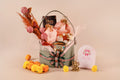 Luxury leather basket gift hamper with premium door hangings, scented candle in a metal jar, chakri-shaped chocolates, cookies box, and sweet box in potli bags – perfect for Diwali and festive gifting.