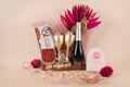 Luxury transparent acrylic bag hamper with wine bottle, 2 wine glasses, Ferrero Rocher chocolates, assorted cracker-shaped chocolates, cookies, tea light candles & premium gold finish playing cards – ideal for Diwali, weddings & corporate gifting.
