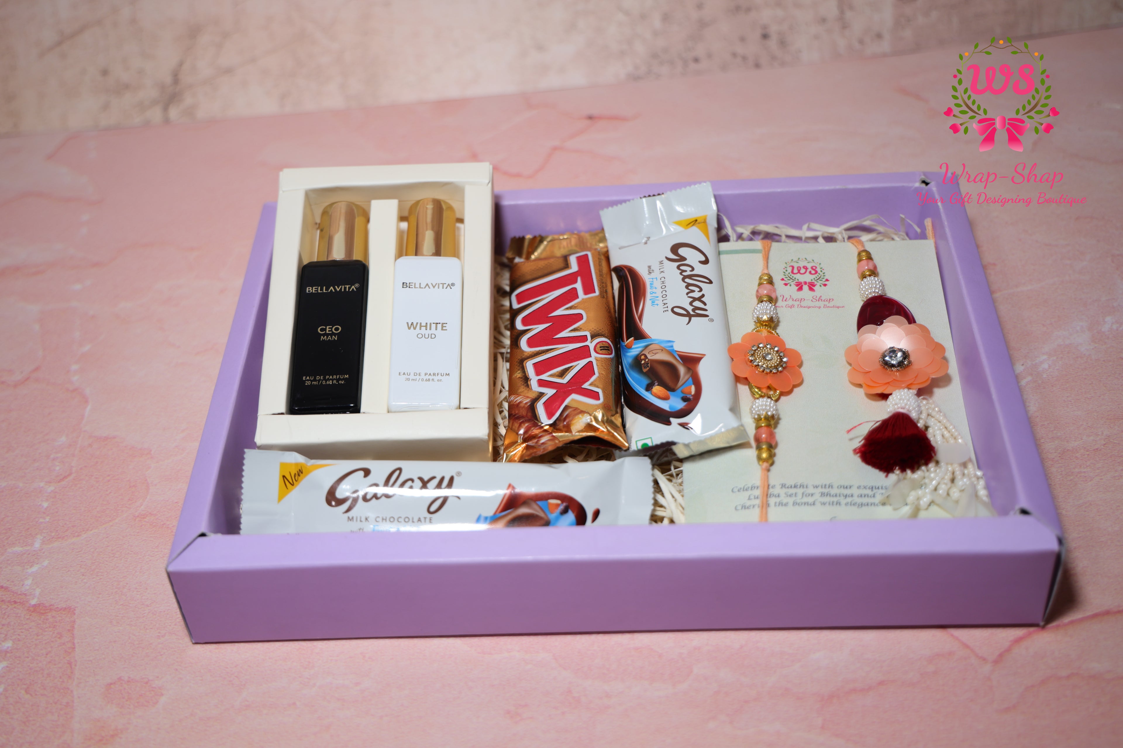Wrap Shap Bhaiya Bhabhi Rakhi hamper with men and women perfume set, chocolates, Rakhi Lumba set in transparent gift box for Raksha Bandhan