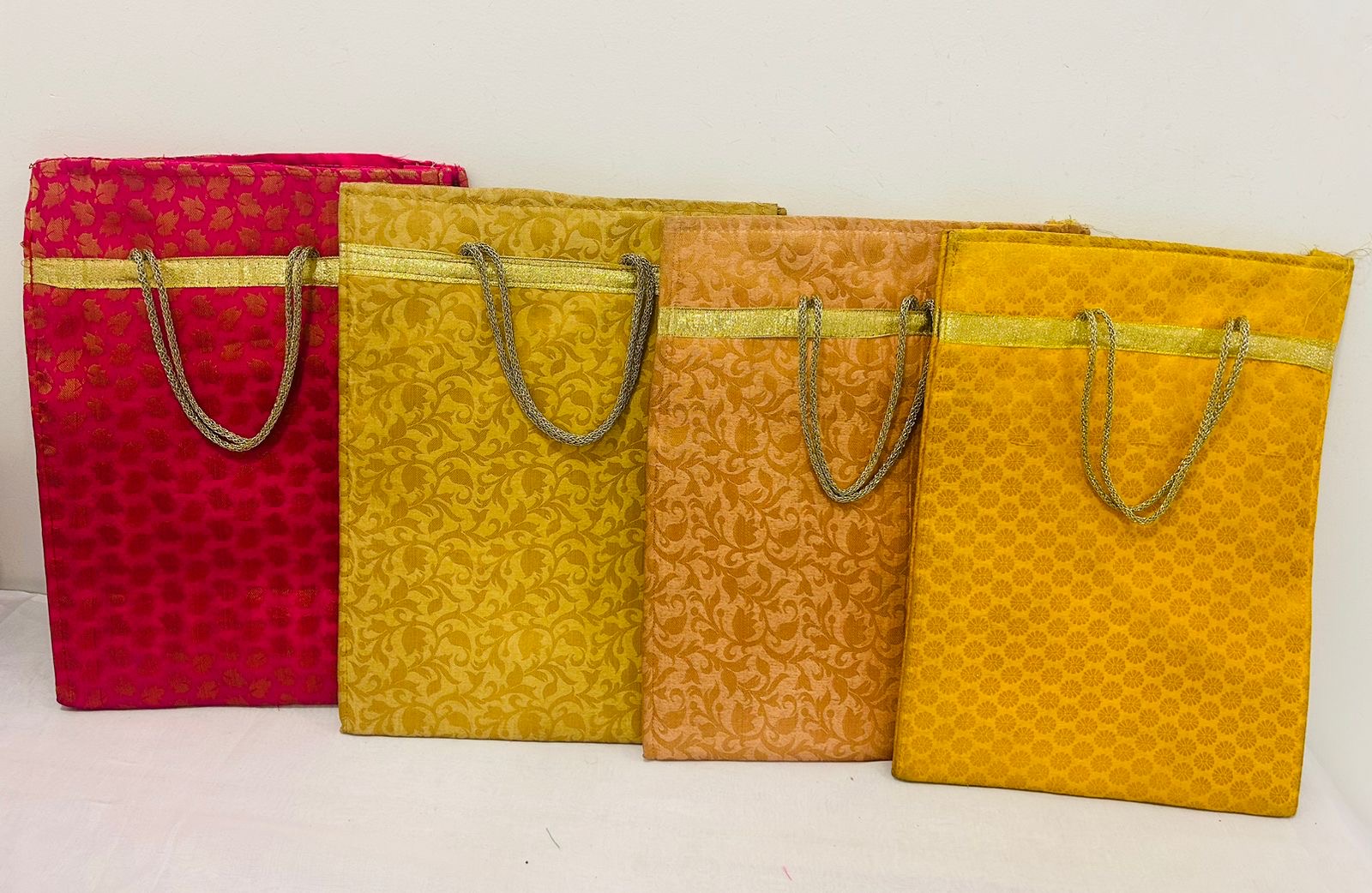 Brocade fabric gifting bags with assorted traditional prints and vibrant colors by Wrap Shap, perfect for weddings and festivals