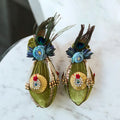 Fresh coconut wrapped in green cloth with blue flowers, pearl tassels, and morpankh for Indian wedding and pooja by Wrap Shap