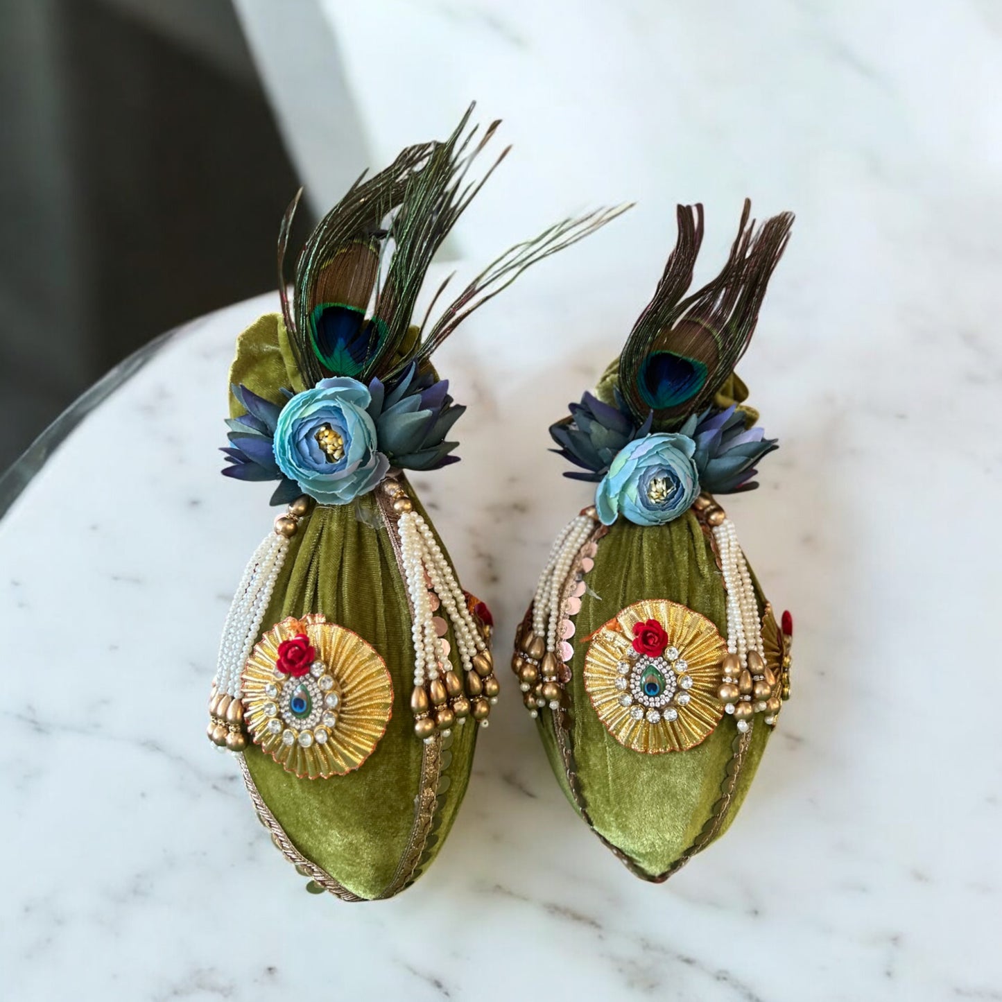 Fresh coconut wrapped in green cloth with blue flowers, pearl tassels, and morpankh for Indian wedding and pooja by Wrap Shap