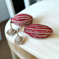Fresh coconut decorated with red lace, “Sada Saubhagyawati” text, and cushion tassels for wedding rituals and pooja by Wrap Shap
