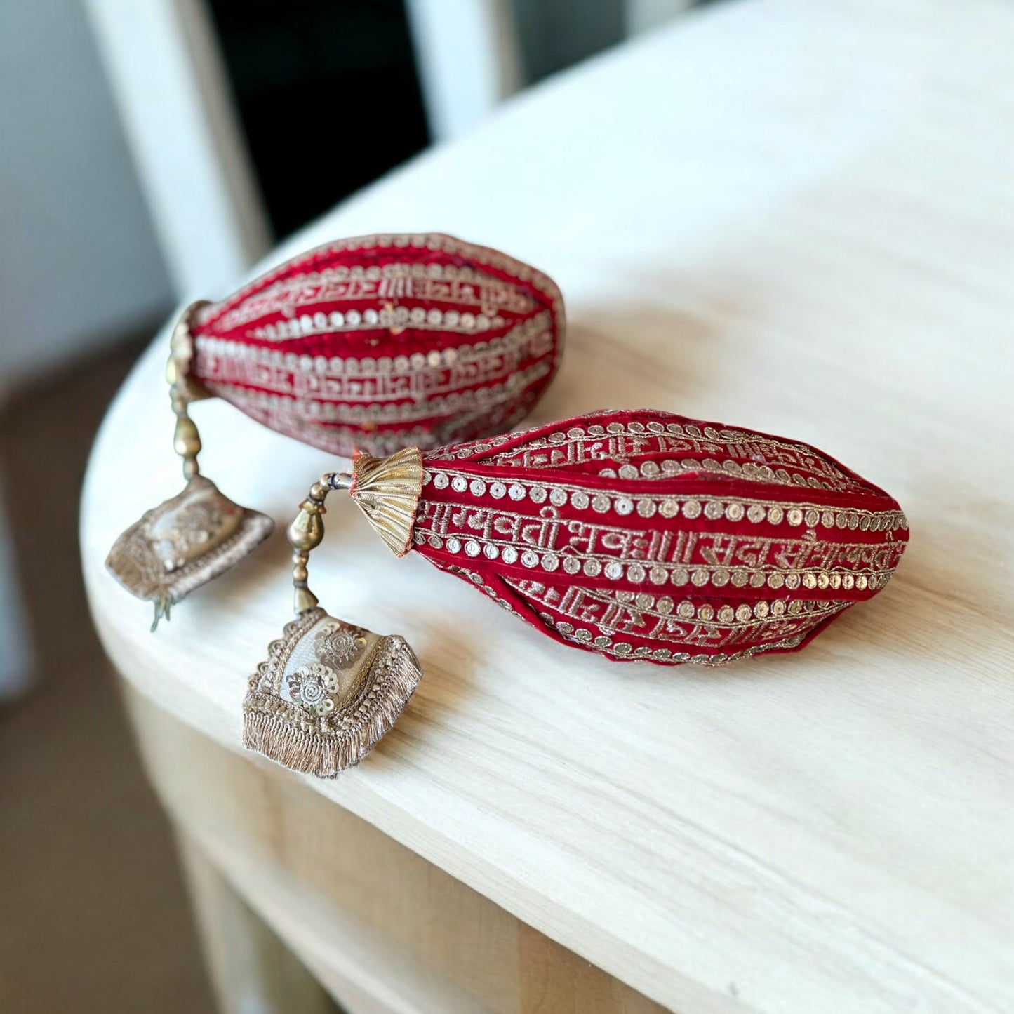 Fresh coconut decorated with red lace, “Sada Saubhagyawati” text, and cushion tassels for wedding rituals and pooja by Wrap Shap