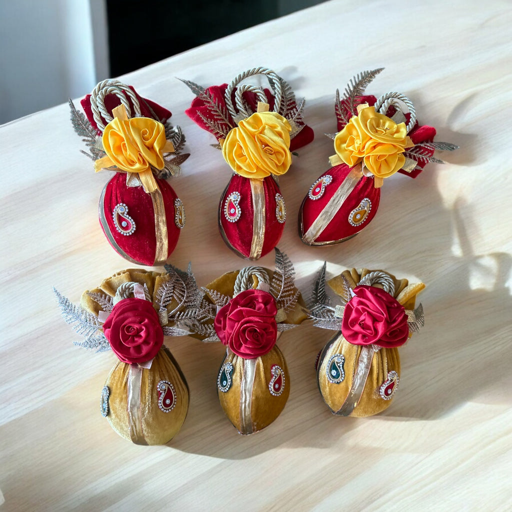 Fresh shagun nariyal decorated with red and yellow velvet cloth, booti, and flower embellishments by Wrap Shap
