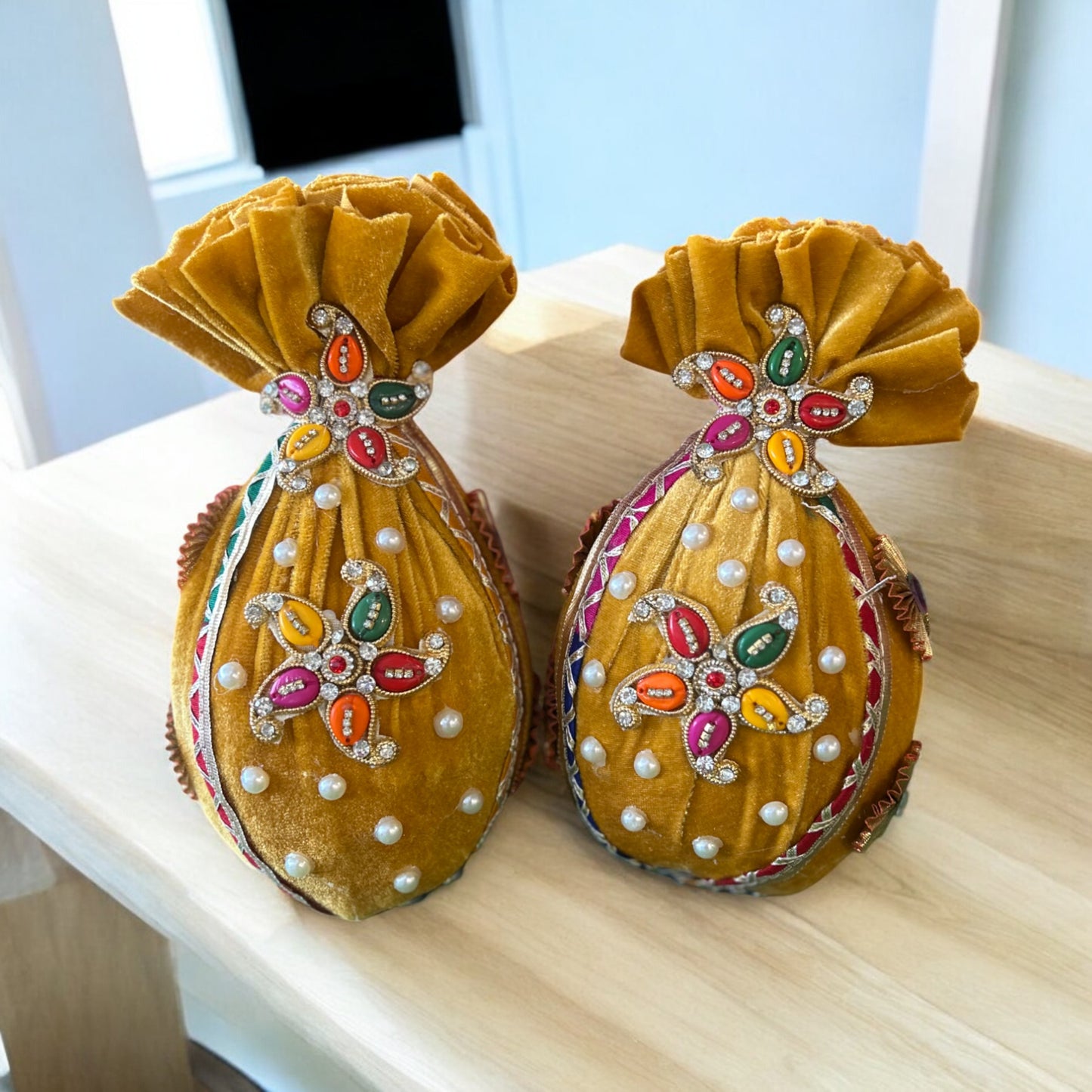 Decorated fresh nariyal wrapped in yellow velvet with booti design for haldi and pooja by Wrap Shap