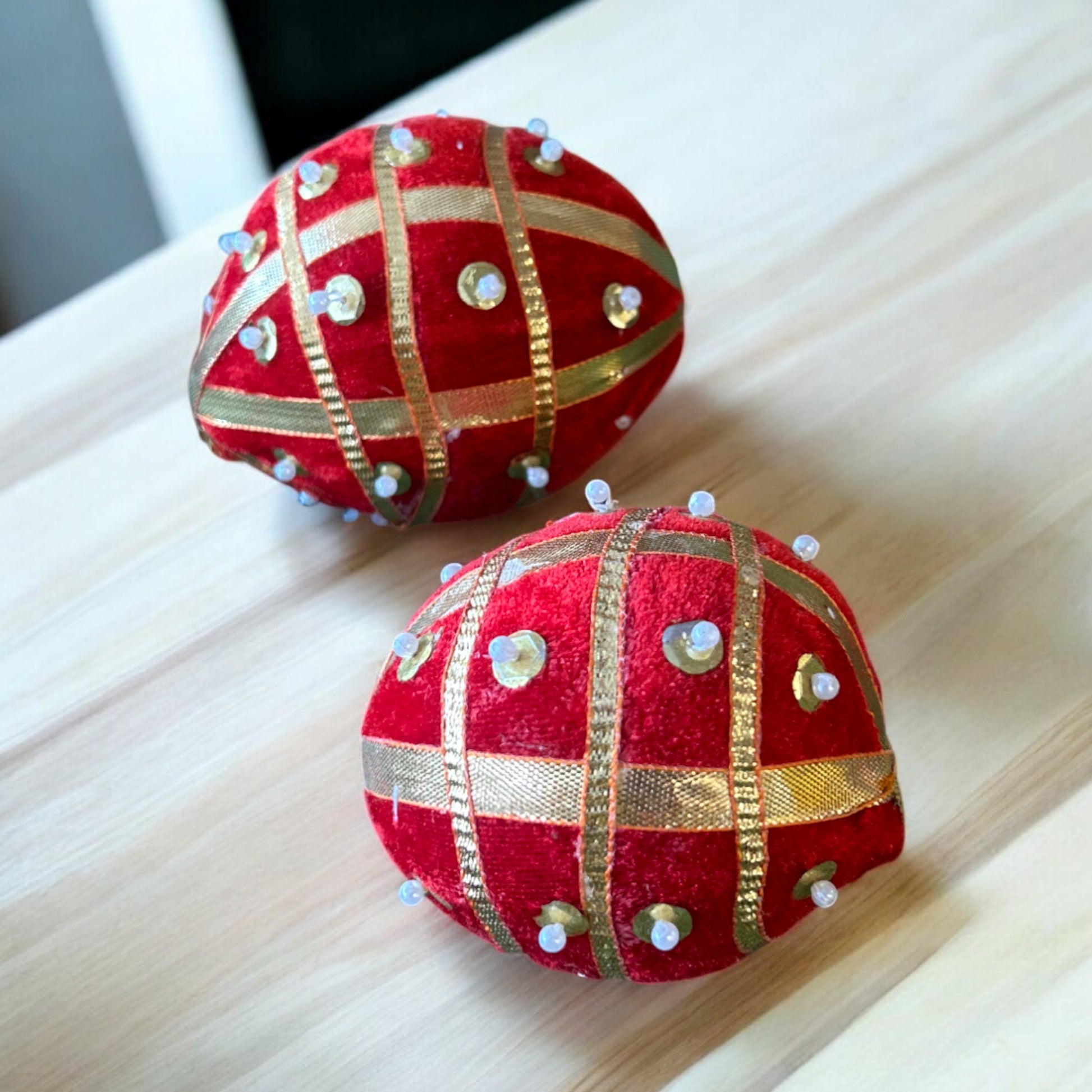 Dry coconut wrapped in red cloth with pearls and gota patti, used for shagun and pooja rituals by Wrap Shap