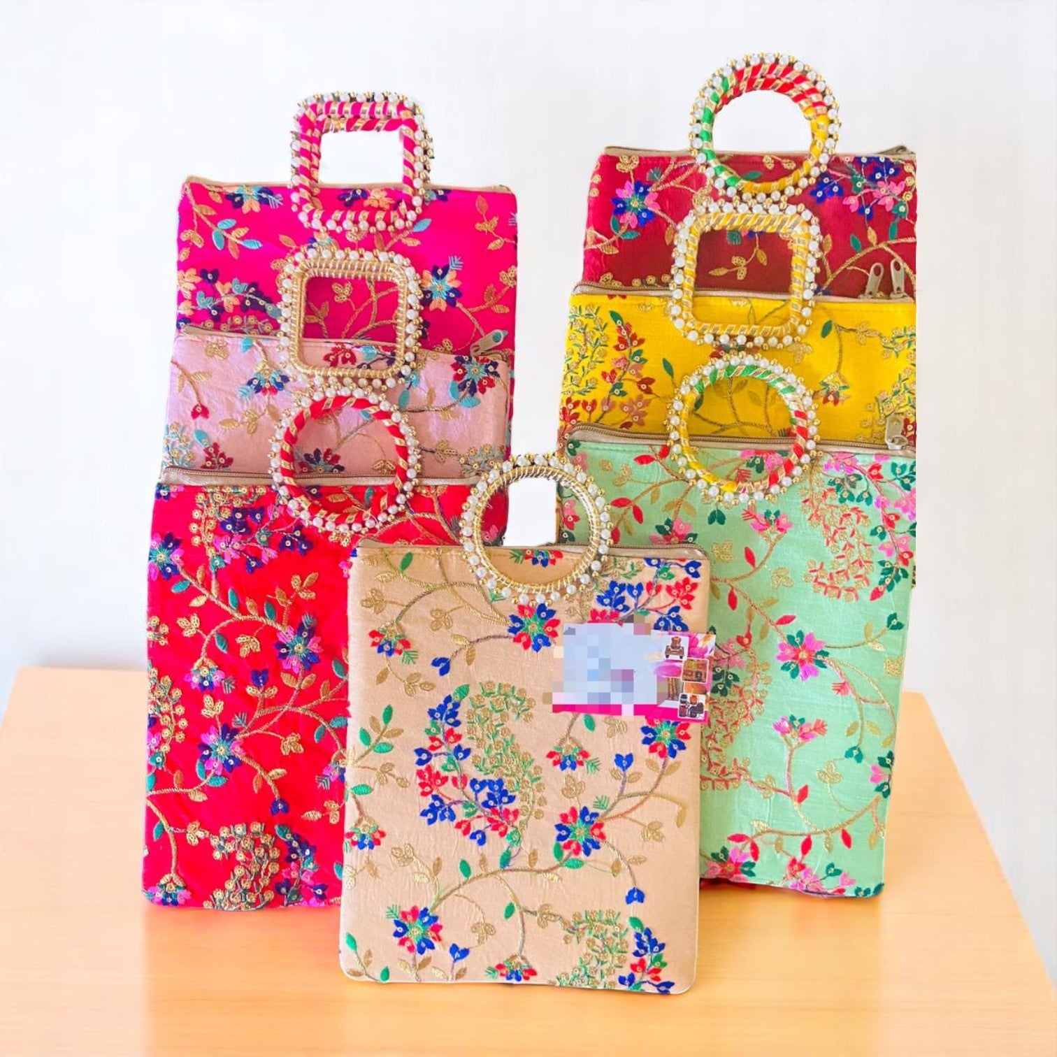 Multicolored leaf embroidered gifting bag with round handle by Wrap Shap, ideal for wedding return favours, Diwali gifts, and festive packaging