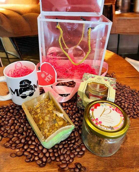 Mother’s Day hamper in decorated PVC box with cookie jar, tea cake, scented candle, and custom name coffee mug from Wrap Shap