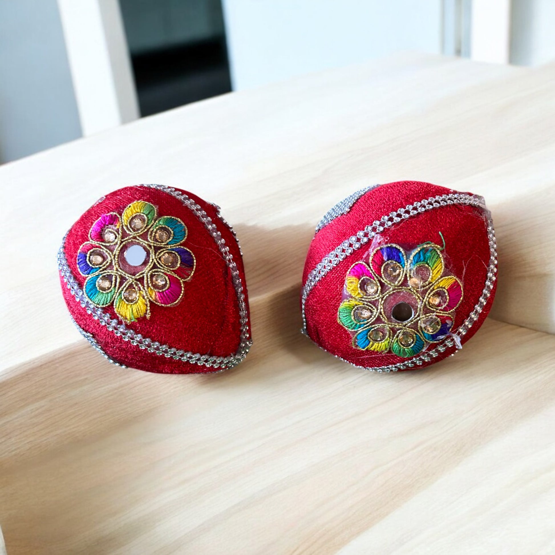 Simple decorated dry coconut wrapped in red cloth with golden booti for shagun and pooja rituals by Wrap Shap