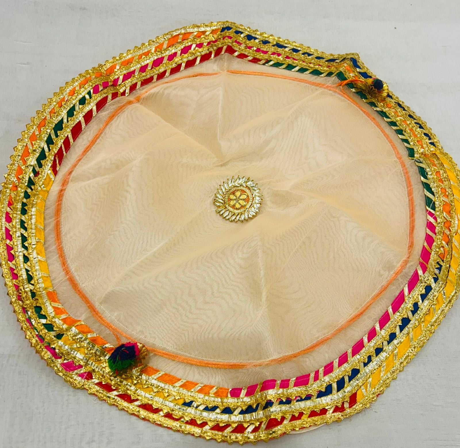 Big size tissue potli with multicolored lace border by Wrap Shap, open as round thaal cover, perfect for pooja, god bharai, wedding, or gifting